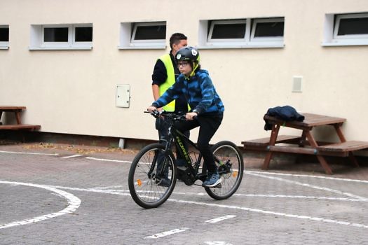 Dziecko jadące na rowerze podczas zdawania na kartę rowerową.